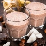 Chocolate banana coconut hazelnut milkshake or smoothie. Healthy organic drink.